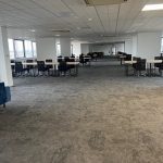 Spacious, empty office with desks.