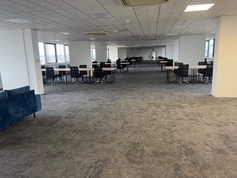Spacious, empty office with desks.